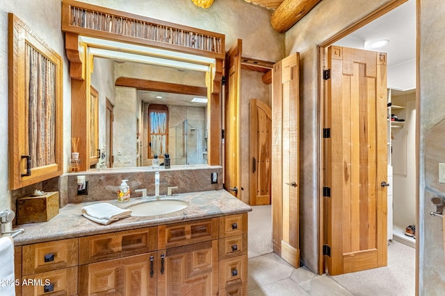 bathroom featuring vanity and a shower