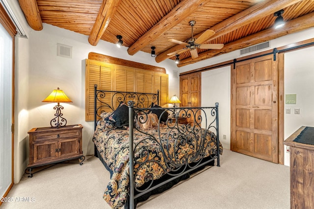 carpeted bedroom with a barn door, wooden ceiling, and beam ceiling