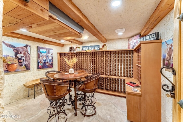 wine room with beamed ceiling