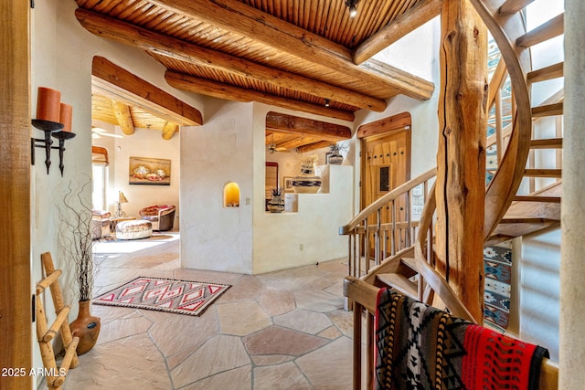 entrance foyer featuring beam ceiling, wood ceiling, and a wealth of natural light