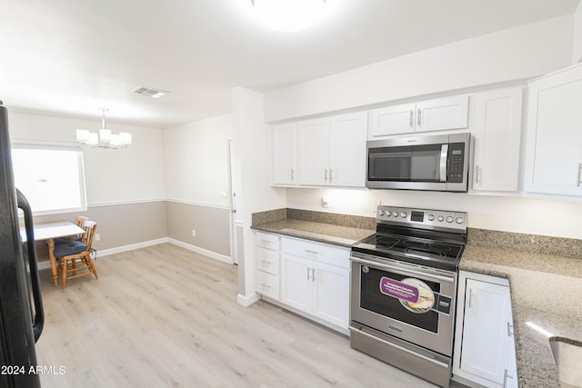 kitchen with hanging light fixtures, appliances with stainless steel finishes, stone countertops, and white cabinets