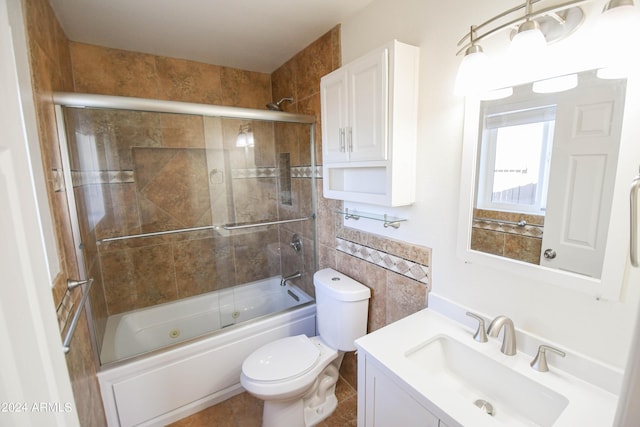 full bathroom featuring vanity, tile walls, shower / bath combination with glass door, and toilet