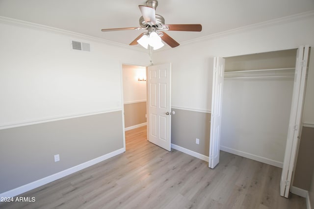 unfurnished bedroom featuring crown molding, ceiling fan, a closet, and light wood-type flooring