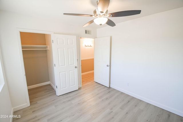 unfurnished bedroom with ceiling fan, light hardwood / wood-style floors, and a closet