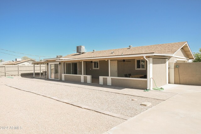 back of house with a sunroom, cooling unit, and a patio area