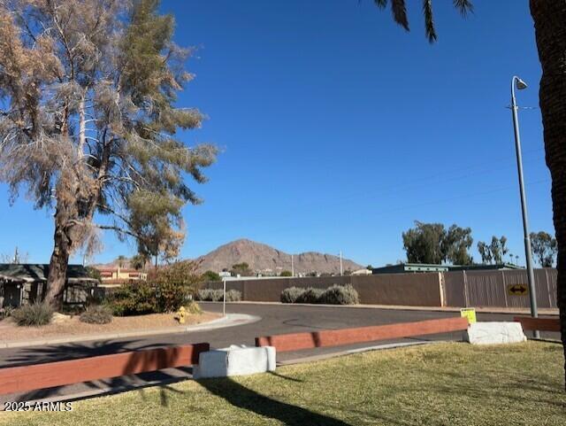 view of community featuring a lawn and a mountain view