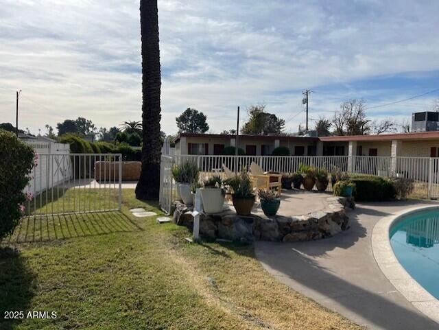 view of yard with a fenced in pool