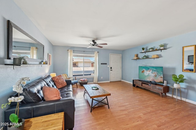 5133 E Keresan St, Phoenix, AZ 85044 - living room featuring a ceiling fan, light wood-style floors, and baseboards
