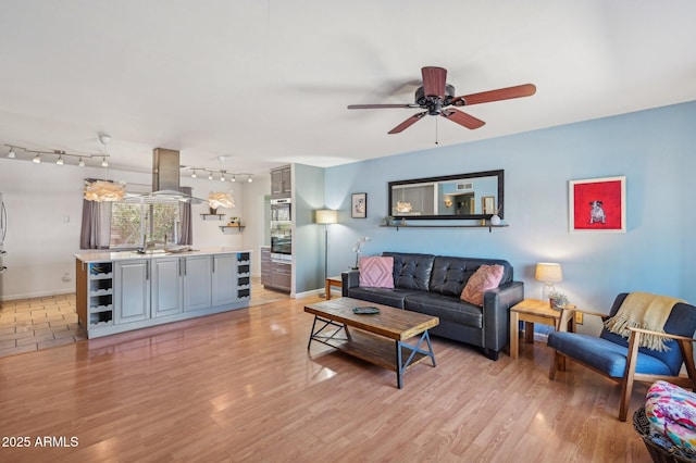 5133 E Keresan St, Phoenix, AZ 85044 - living area featuring ceiling fan, rail lighting, baseboards, and light wood-type flooring