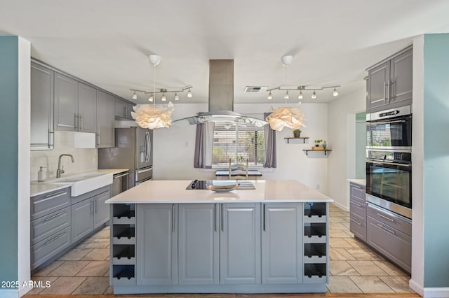 5133 E Keresan St, Phoenix, AZ 85044 - kitchen featuring open shelves, gray cabinets, a center island, a sink, and light countertops