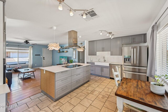 5133 E Keresan St, Phoenix, AZ 85044 - kitchen featuring appliances with stainless steel finishes, gray cabinetry, a sink, track lighting, and tasteful backsplash