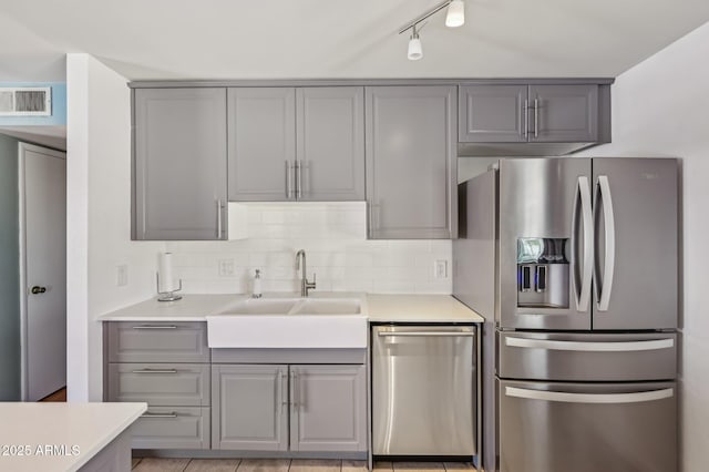 5133 E Keresan St, Phoenix, AZ 85044 - kitchen featuring stainless steel appliances, gray cabinets, a sink, and light countertops