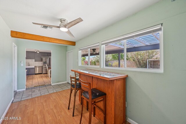 5133 E Keresan St, Phoenix, AZ 85044 - dining area featuring a ceiling fan, baseboards, and light wood-style floors