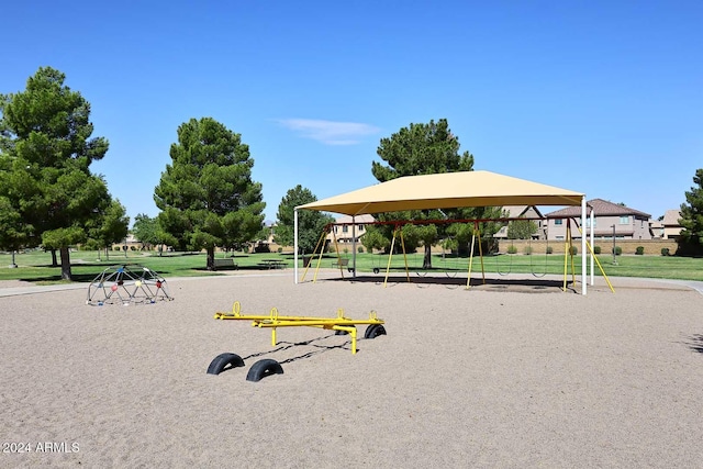 view of property's community with playground community and a yard