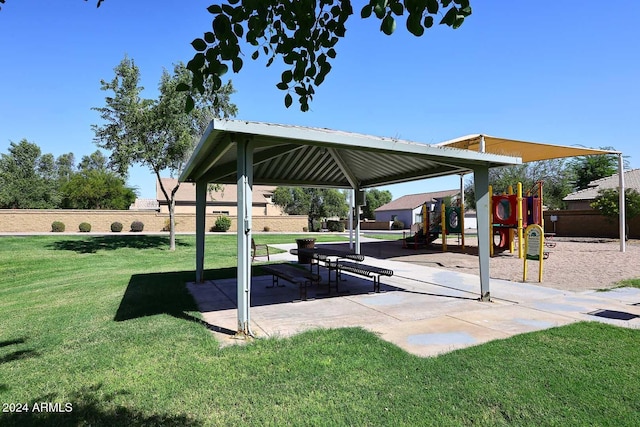 view of property's community featuring a yard, playground community, a gazebo, and fence