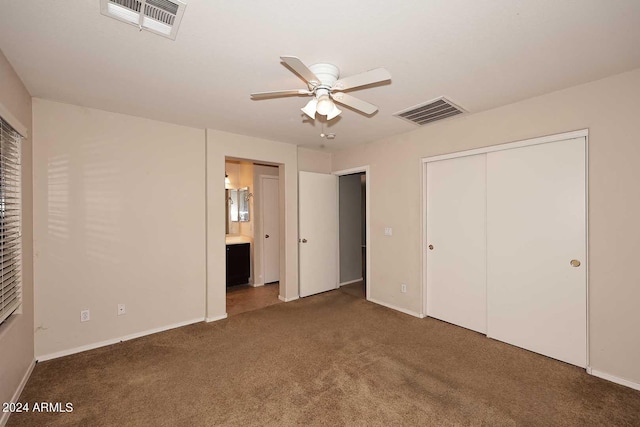 unfurnished bedroom with ensuite bathroom, carpet, visible vents, and baseboards