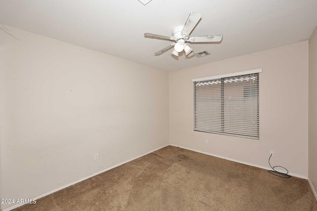 unfurnished room featuring a ceiling fan, carpet, visible vents, and baseboards