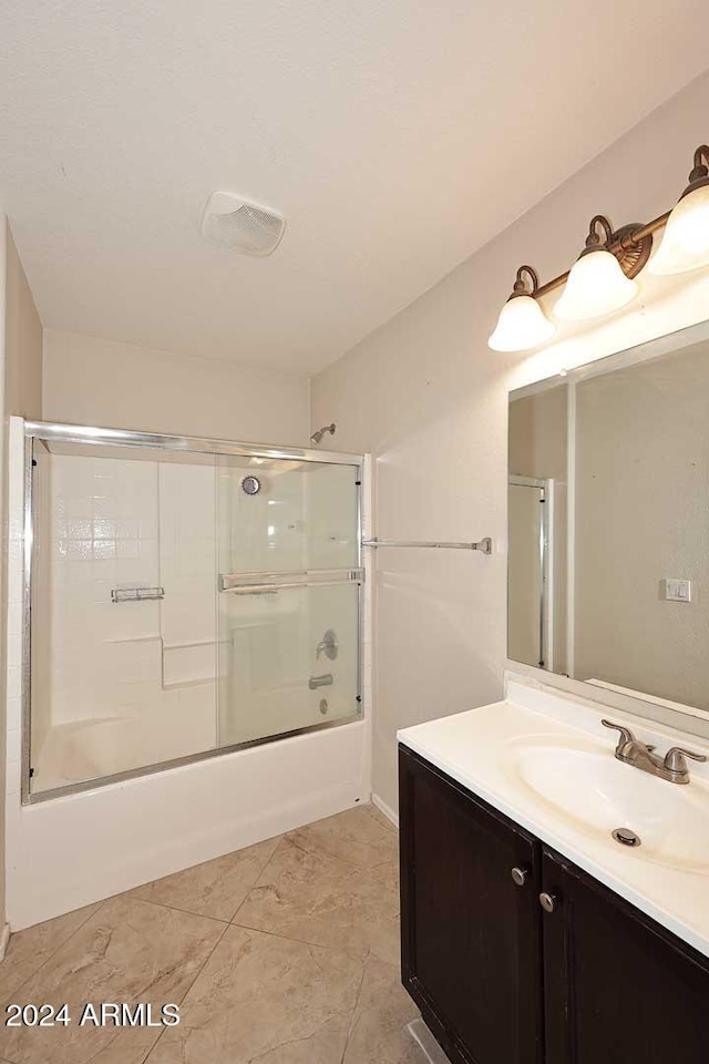 bathroom with shower / bath combination with glass door and vanity