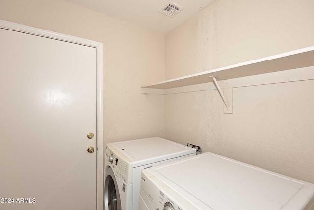 laundry room featuring laundry area, washing machine and clothes dryer, and visible vents