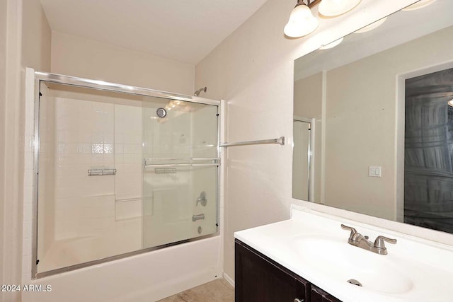 bathroom featuring shower / bath combination with glass door and vanity