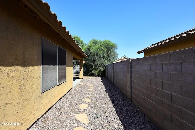 view of home's exterior with fence and stucco siding