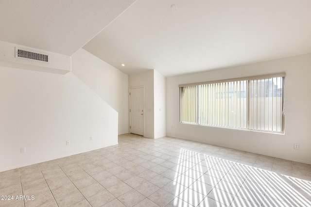 unfurnished room with light tile patterned floors and plenty of natural light