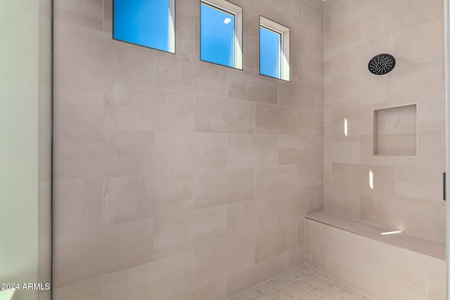 bathroom featuring tiled shower