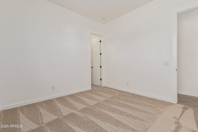 unfurnished room with light carpet