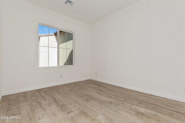 spare room featuring light hardwood / wood-style flooring