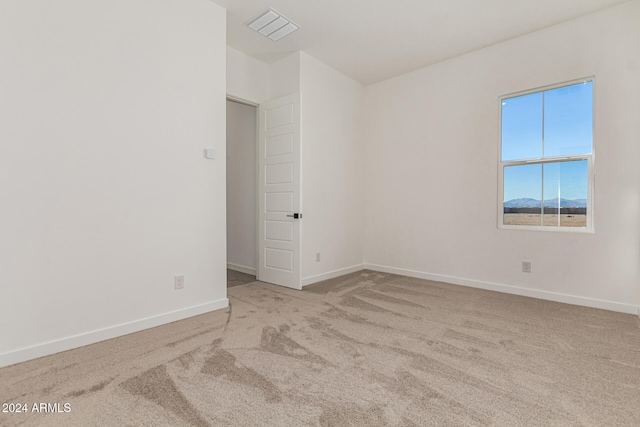 unfurnished room featuring light colored carpet