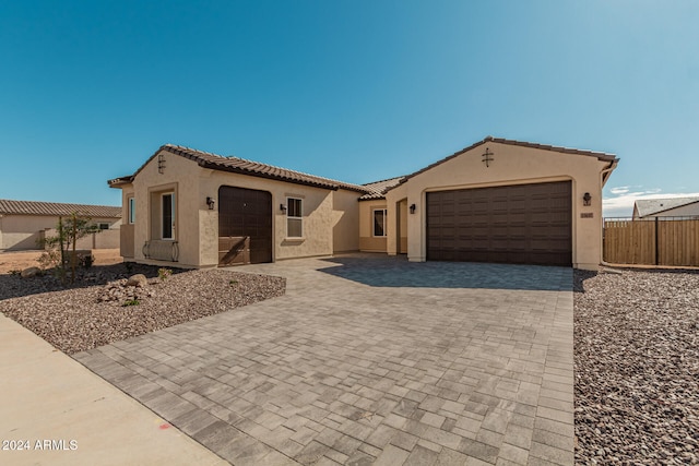 mediterranean / spanish-style home with a garage