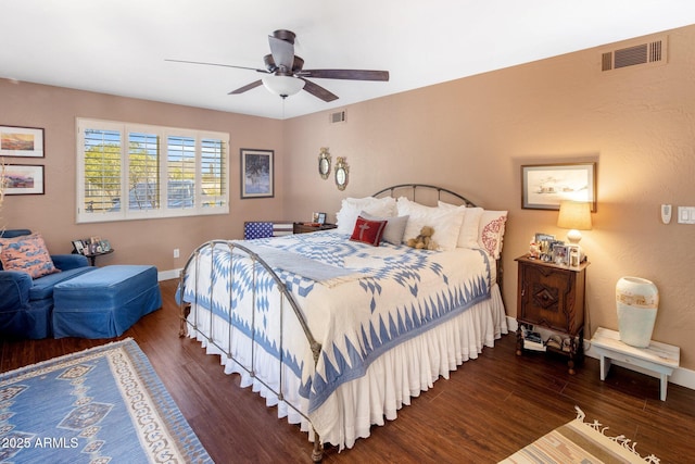 bedroom with visible vents, baseboards, and wood finished floors