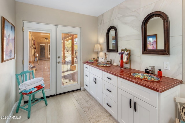 bar featuring french doors and a sink