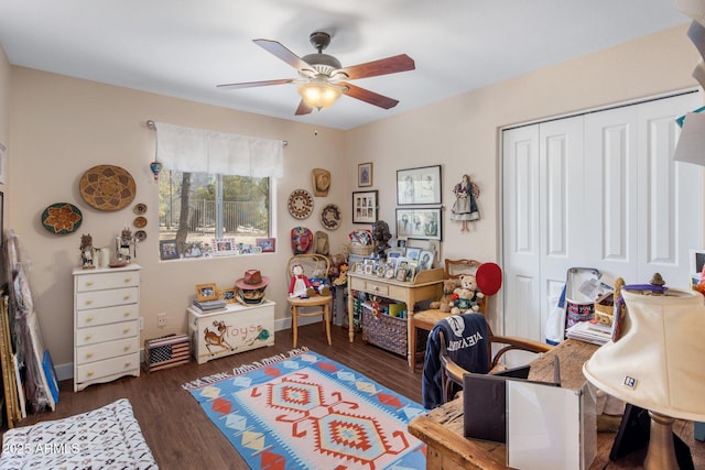 interior space featuring baseboards, ceiling fan, and wood finished floors