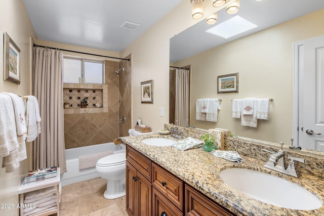 full bathroom with a sink, visible vents, toilet, and a skylight