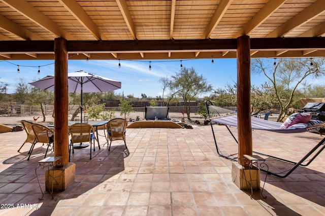 view of patio / terrace with outdoor dining space and fence