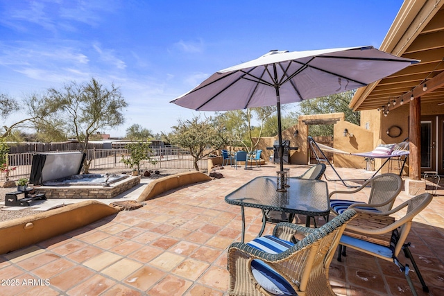 view of patio with outdoor dining area and fence