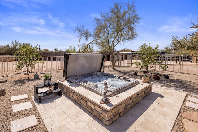 view of patio with a covered hot tub and fence private yard