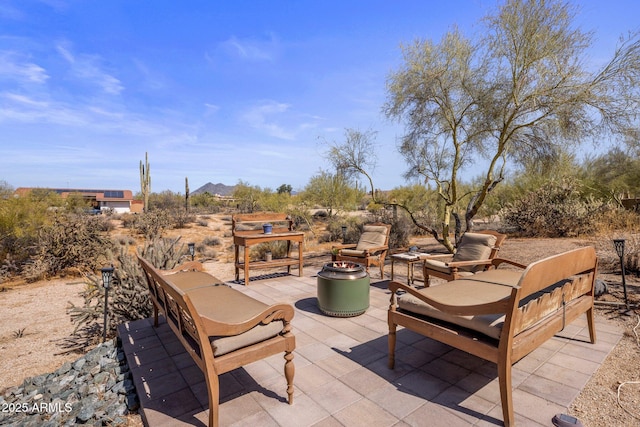 view of patio / terrace with an outdoor living space with a fire pit