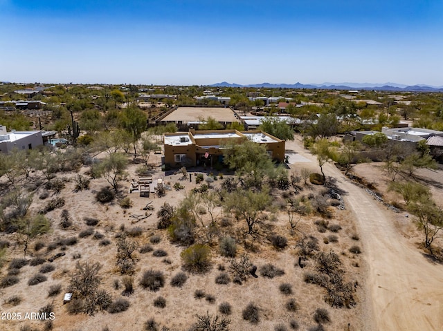 birds eye view of property featuring a mountain view and a desert view