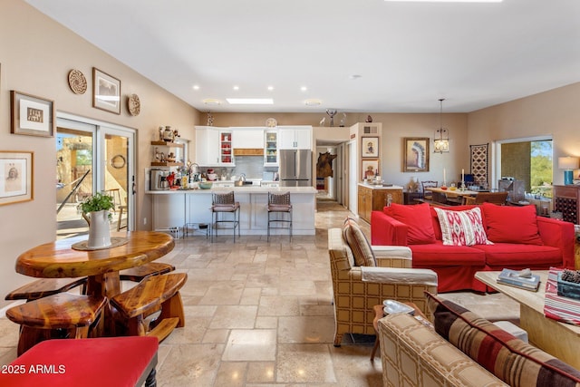 living area with stone tile flooring and recessed lighting