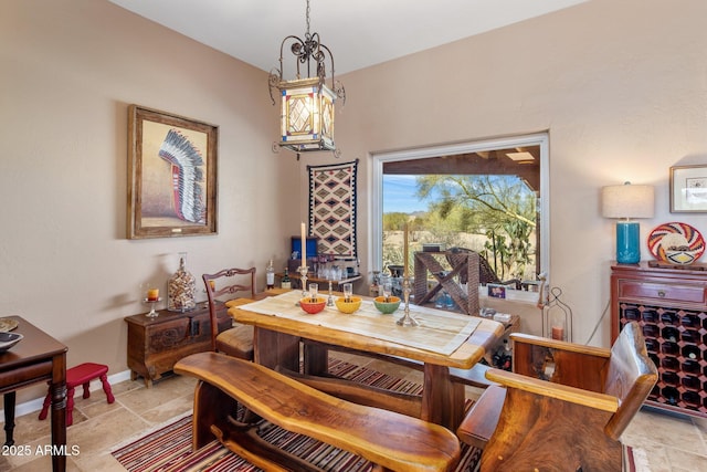 dining space with baseboards and stone finish flooring