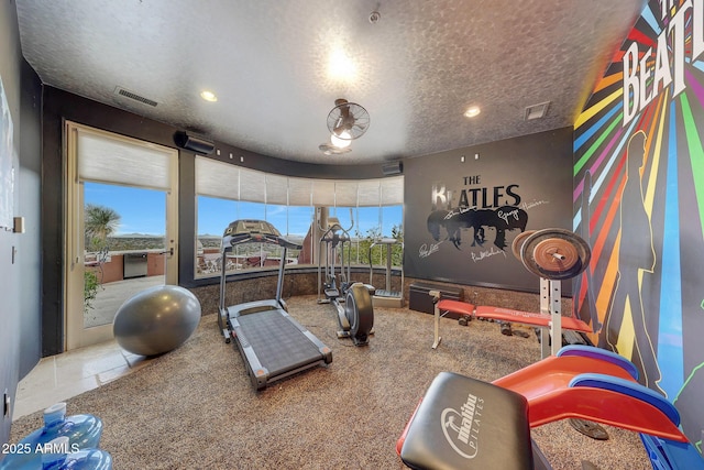 workout area with a textured ceiling