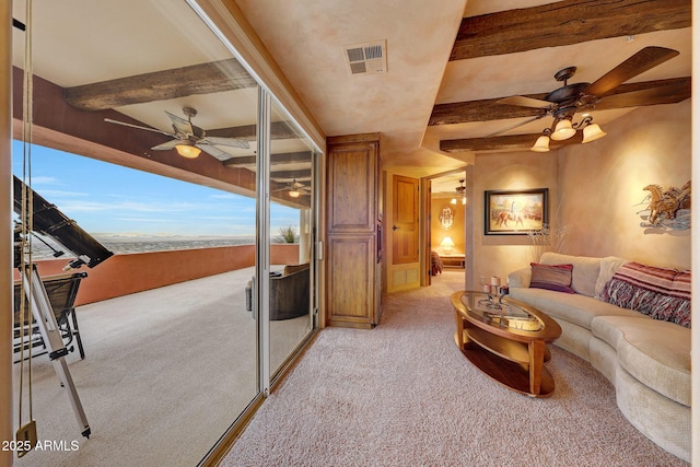 living room featuring beamed ceiling, light colored carpet, and ceiling fan