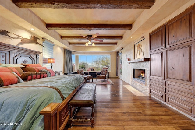 bedroom with beam ceiling and dark hardwood / wood-style floors