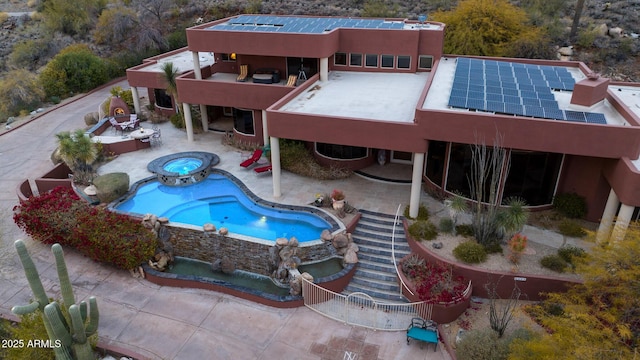 view of swimming pool featuring an in ground hot tub, a patio area, and an outdoor fire pit