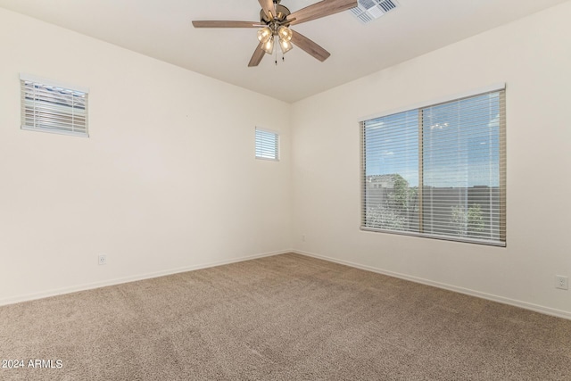 unfurnished room with ceiling fan and carpet