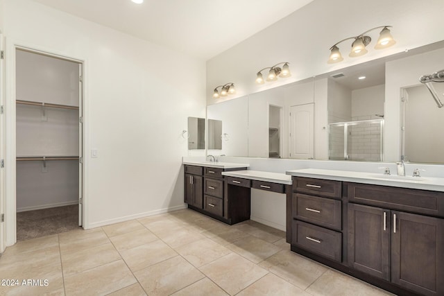 bathroom featuring tile patterned flooring, vanity, and walk in shower