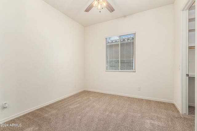 empty room with light colored carpet and ceiling fan