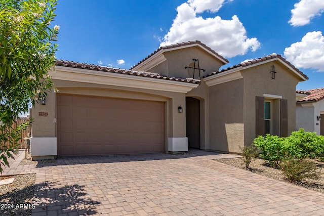 mediterranean / spanish house featuring a garage